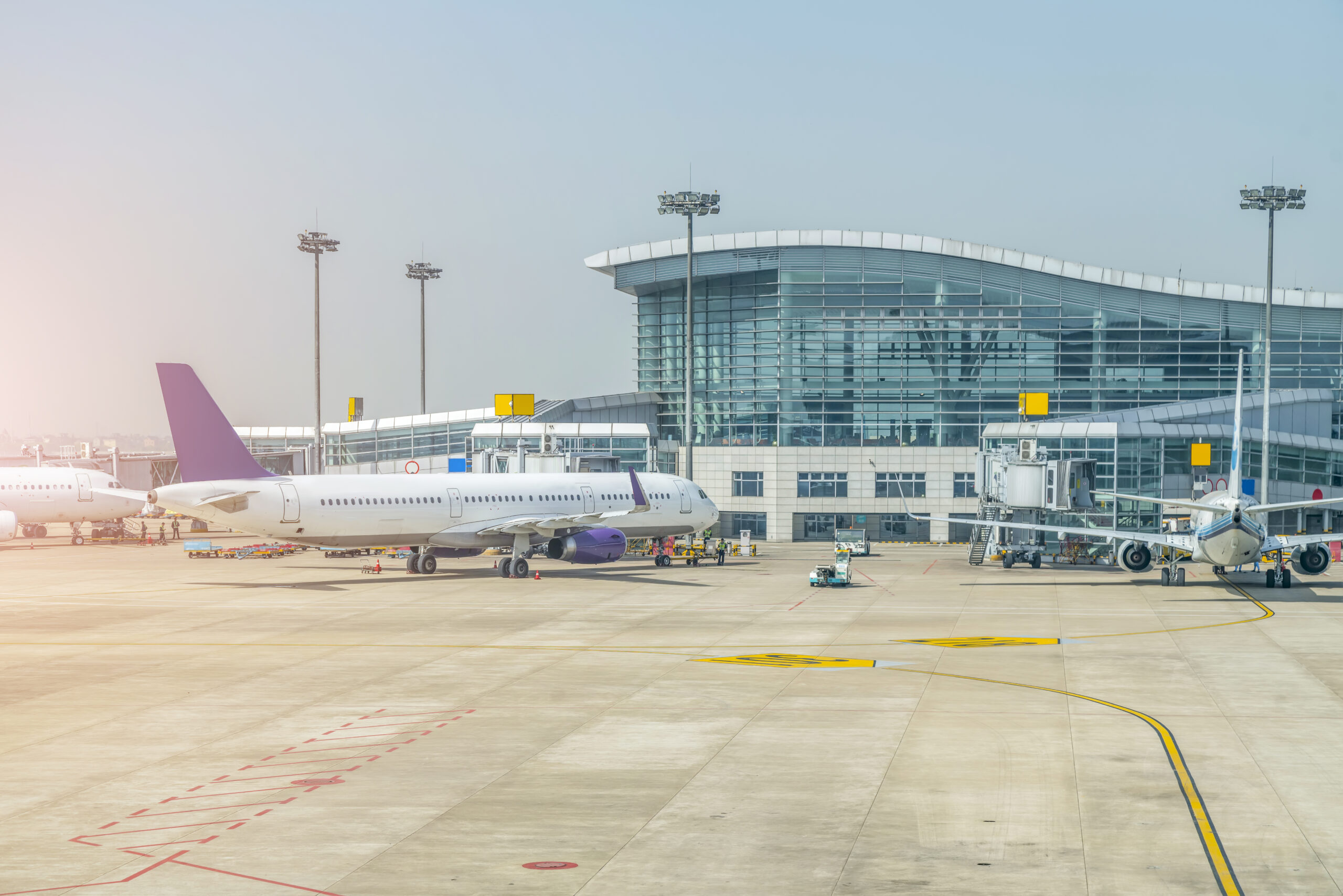 Sialkot International Airport terminal building with a plane parked in front.