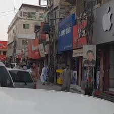Crowded street view of Liaquat Bazaar in Quetta with colorful shops, traditional textiles, and busy shoppers.
