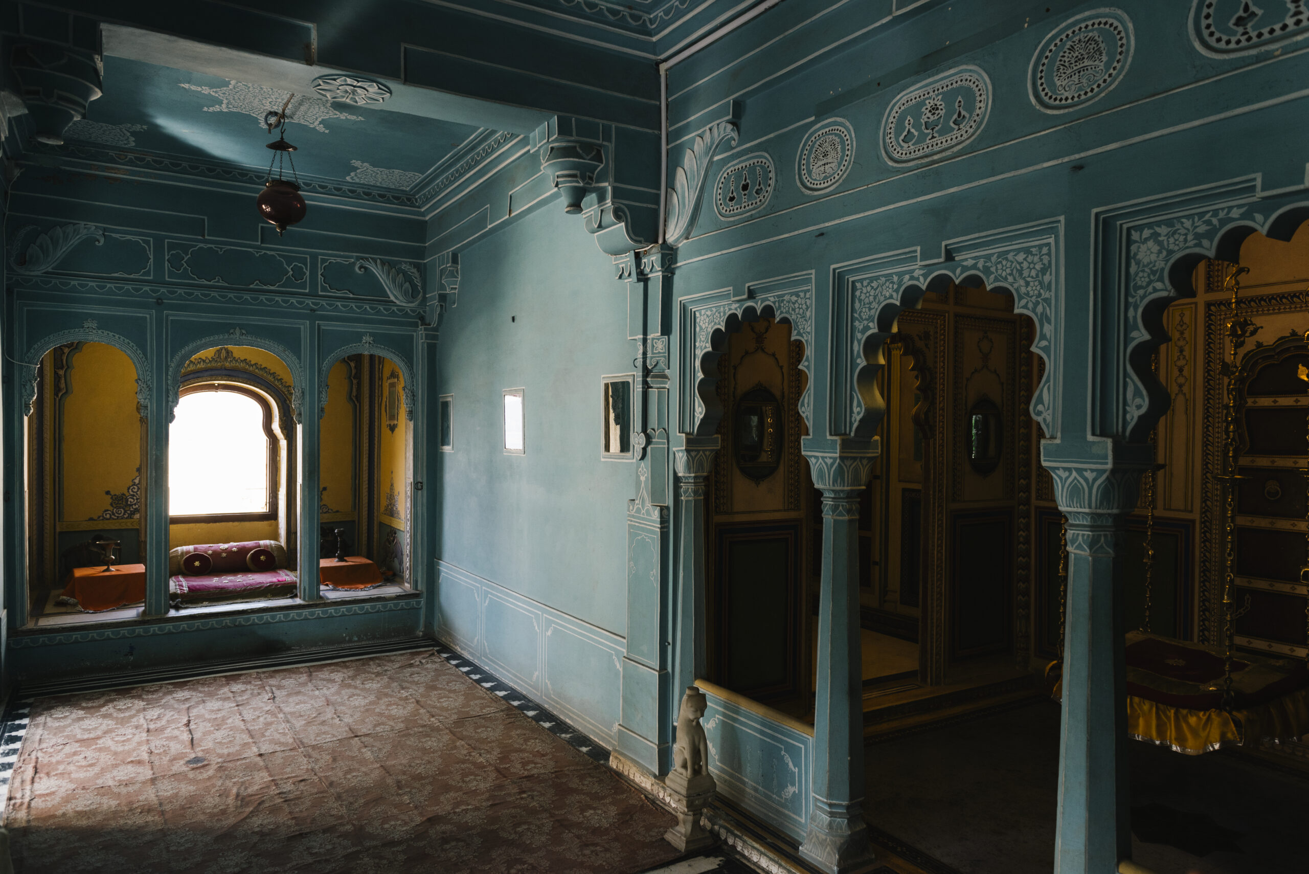 “Sadh Belo Temple on an island in the Indus River near Sukkur, featuring colorful domes, traditional Hindu architecture, and serene surroundings under a clear sky.”