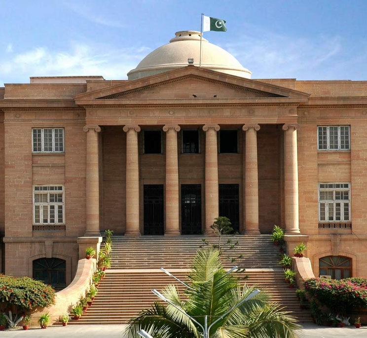 “Front view of Sindh High Court building in Karachi, showcasing its grand colonial architecture with pillars and detailed stonework.”