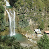 Sajikot Waterfall plunging into a crystal-clear pool surrounded by forested cliffs in Abbottabad District, Khyber Pakhtunkhwa