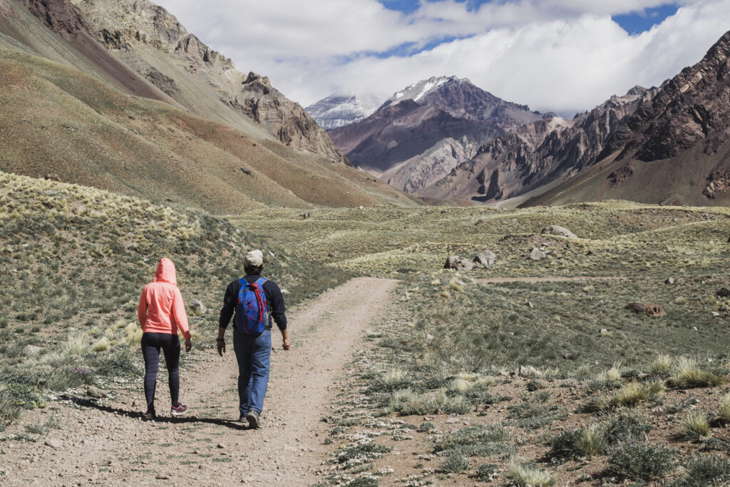 Couple walking on a mountain track during rainy weather in Pakistan
