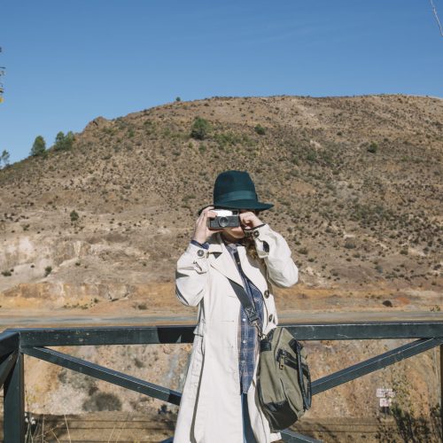 woman-focusing-with-vintage-camera